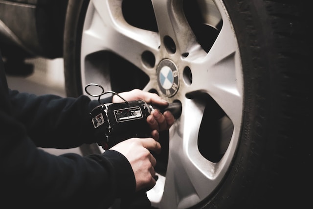 Car mechanic working under a vehicle